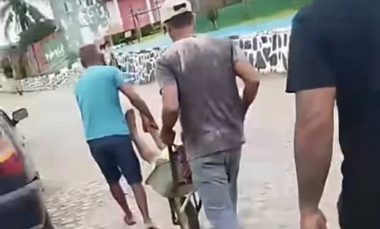homem levado em carro de mão em Pedrão